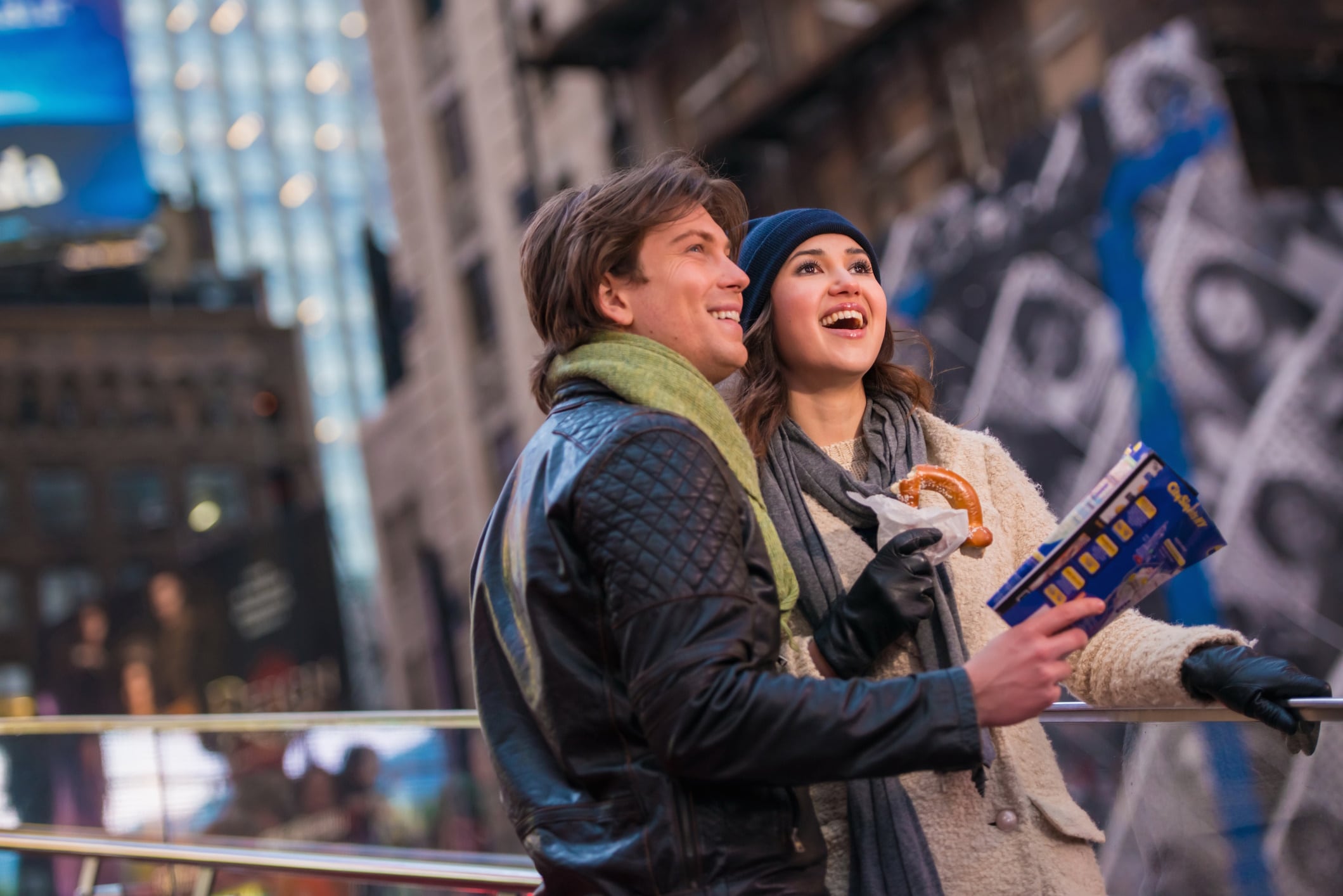 Young couple on vacation with map and bagel, New York City,